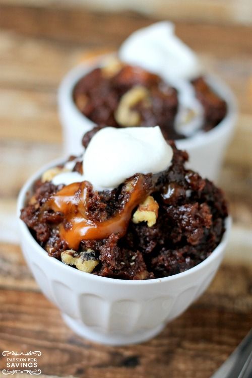 two small white bowls filled with dessert on top of a wooden table