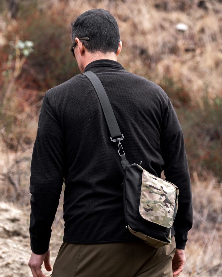 Made with multicam paneling, bolstr Small Carry Disruptive Camo adds a touch of tactical for style. This mini satchel bag alternative is made from military grade materials just in case. Multicam Cordura® Designed with BA7ANCE™ Pocket Research Minimalist Everyday Carry Made in USA Carry what you need: Five (5) pockets and d-rings for smartphone, wallet, passport, keys, sunglasses, Air Pods, external battery, charging cables, tablet, but not much more. Dimensions (Max): L 9" (229mm) x W 3 (76mm) x Mini Satchel Bag, Outdoor Pouch Chest Bag With Anti-theft Pocket, Military Style Nylon Bags For Outdoor, Military Style Durable Outdoor Bags, Military Style Bags With Adjustable Strap For Outdoor, Multicam Black, Edc Bag, Military Style Bags With Pockets For Hiking, External Battery