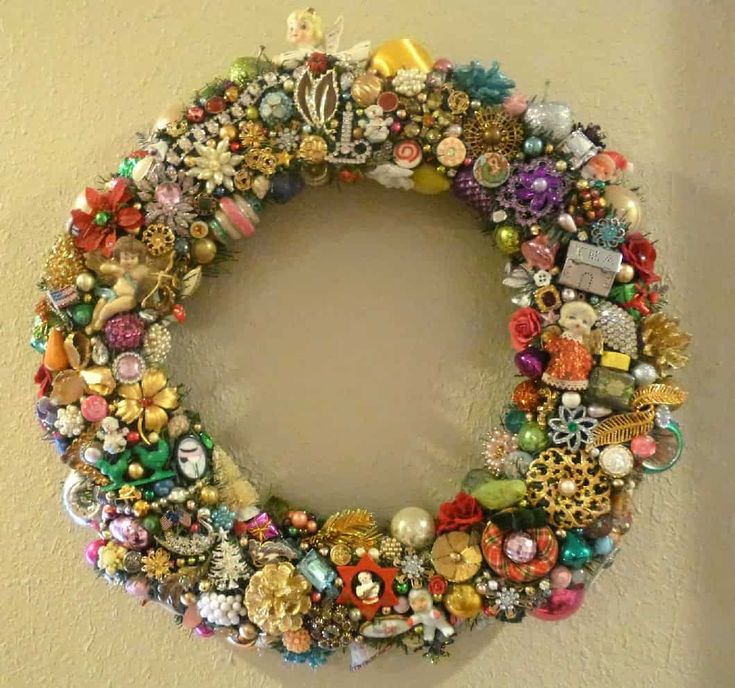 a close up of a wreath made out of buttons and other items on a wall