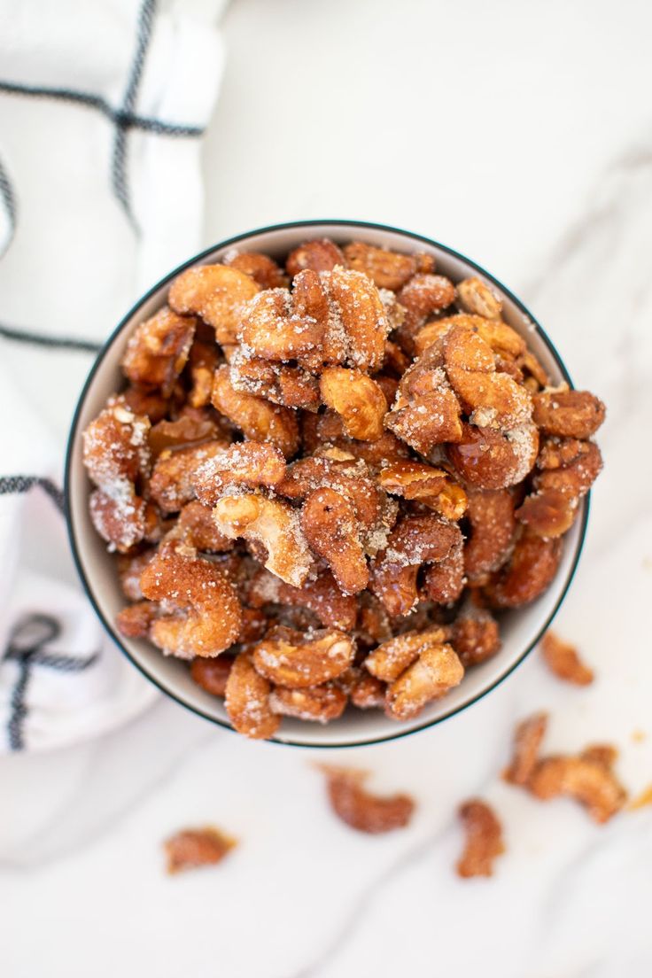 a bowl filled with nuts sitting on top of a counter