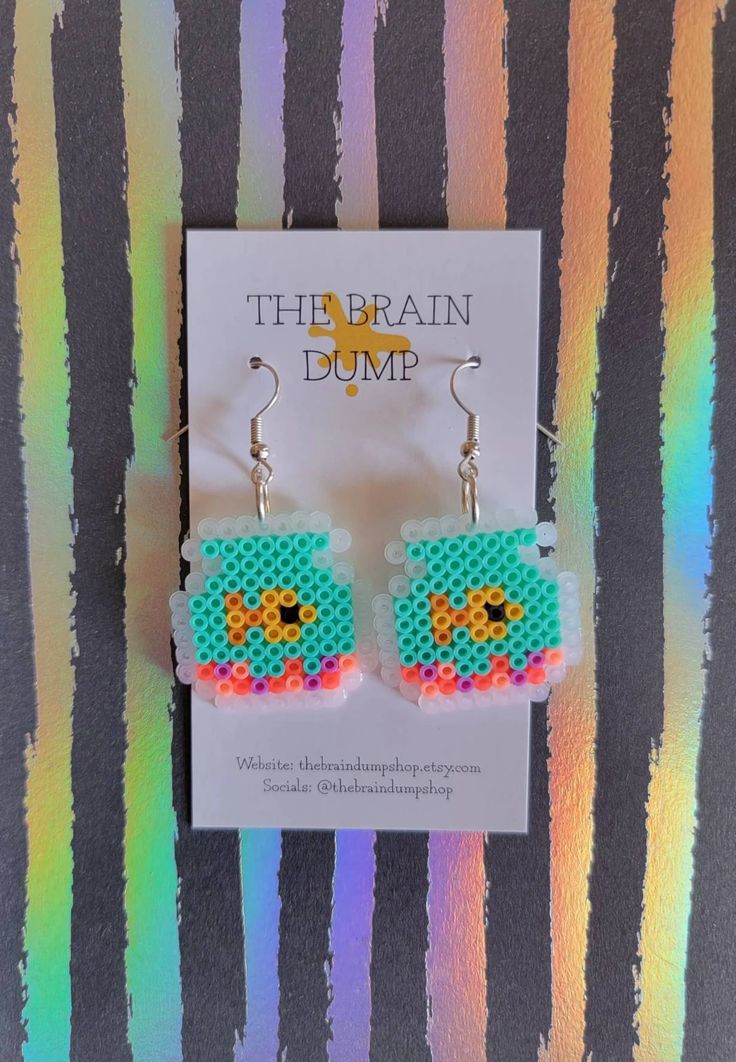 the beaded earrings are designed to look like an image of a baby yoshi