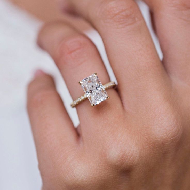 a woman's hand with a diamond ring on it