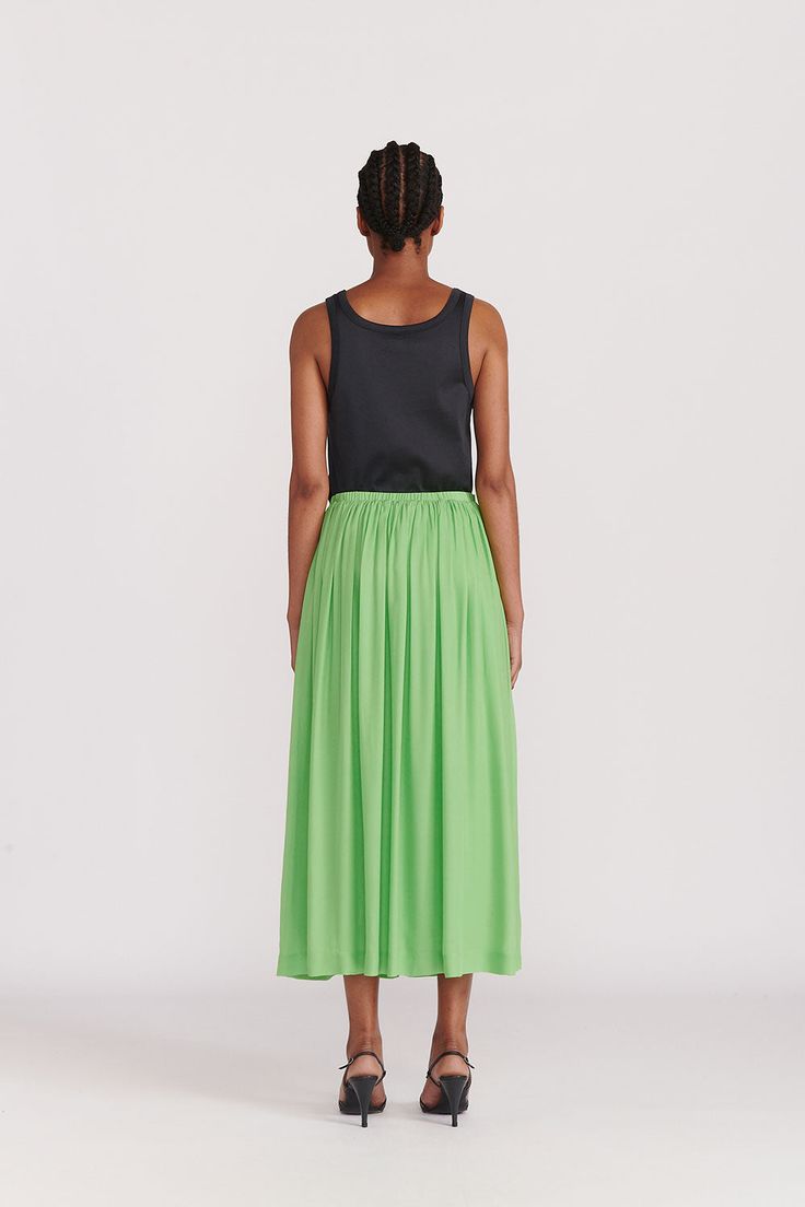 A Gathered ankle length skirt with elastic waistband in an excellent green silk. Hidden pockets and a full lining make this a no-brainer choice for adding this season's color to your palate. This color (Absinth) is also available in the Citron Organic Silk Dress. WHY WE LOVE IT INDRESS was founded in Paris in 2001 by Dutch designer Wies Schulte with the desire to combine elegance, timeless shapes and vibrant colors. Its collections are based on exclusive dyes and carefully selected fabrics, incl Green Silk Bottoms For Spring, Green Relaxed Midi Skirt, Green Silk Bottoms For Summer, Spring Silk Skirt With Pleated Waist, Summer Silk Maxi Skirt With Voluminous Fit, Silk Voluminous Skirt Bottoms For Summer, Silk Pleated Waist Midi Skirt, Silk Midi Skirt With Pleated Waist, Flowy Silk Maxi Skirt