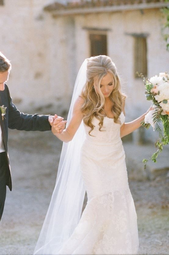 the bride and groom are holding hands