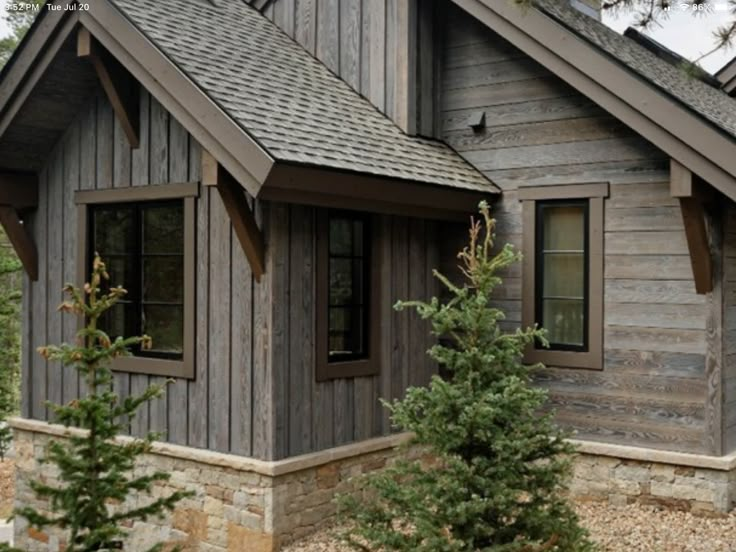 a small wooden house sitting in the middle of a forest