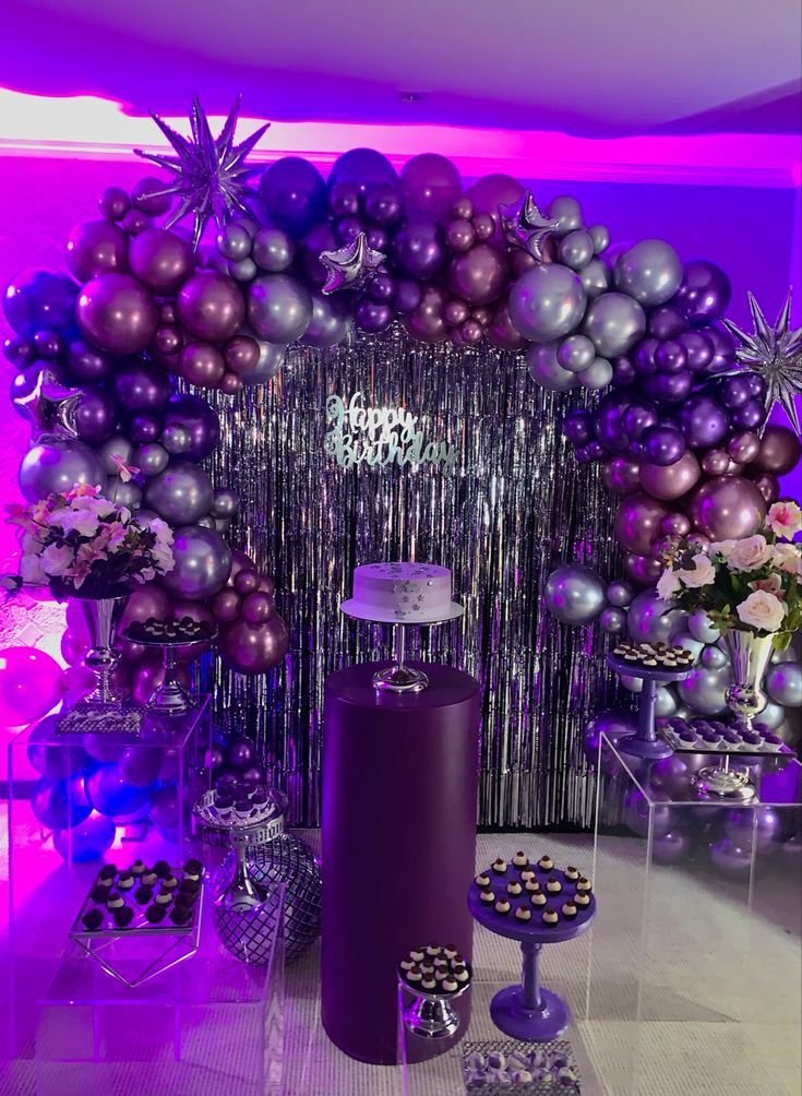 purple and silver decorations are on display in the room