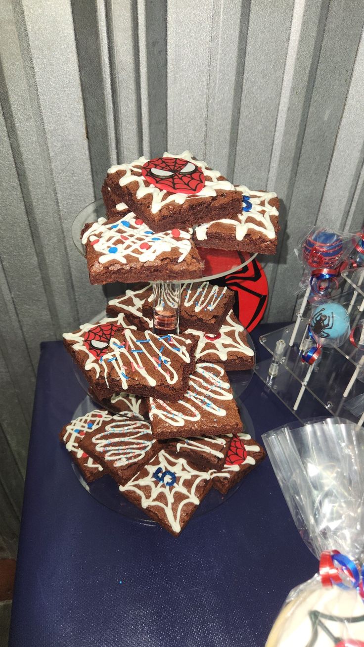 several pieces of chocolate cake sitting on top of a blue table next to some candy