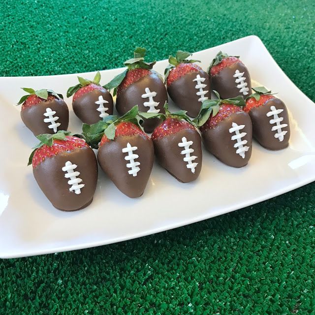 chocolate covered strawberries are arranged in the shape of footballs on a white plate