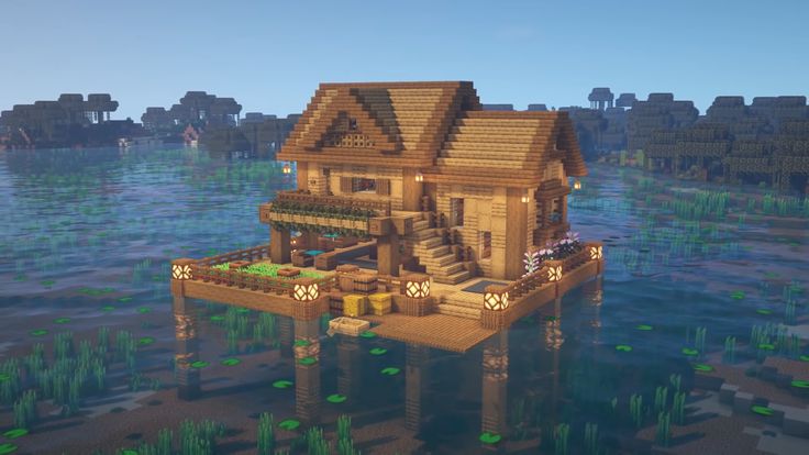 a house in the middle of some water with plants around it and grass growing on the ground