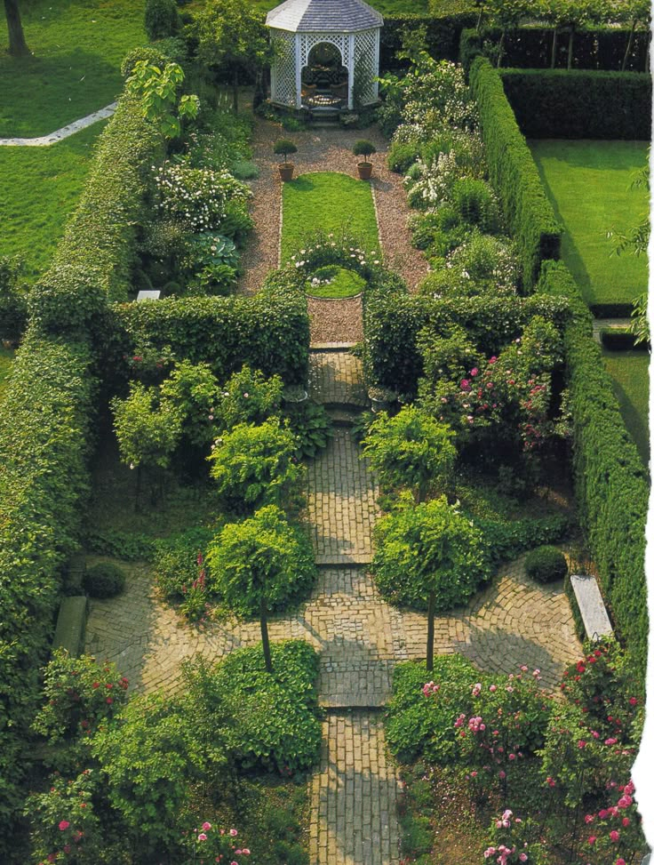 an aerial view of a garden with many trees and bushes