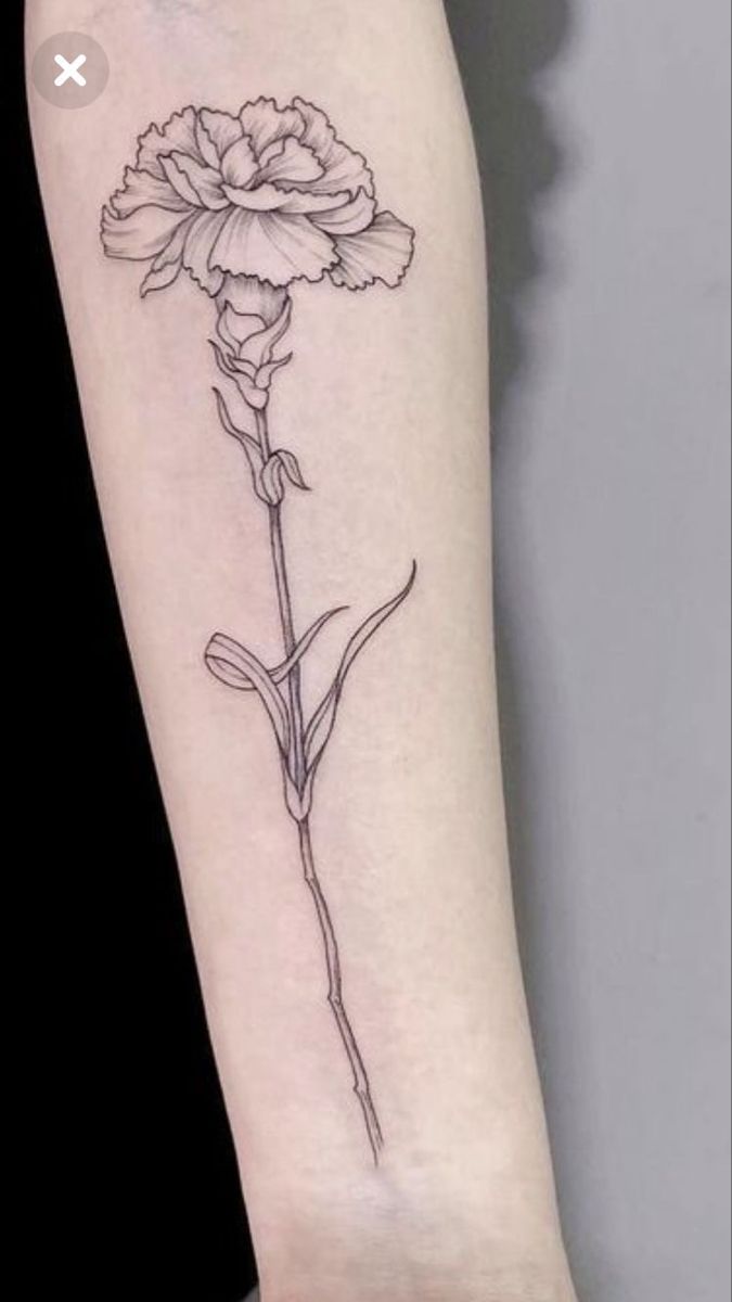 a single flower tattoo on the arm