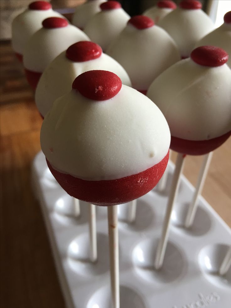 some white and red cake pops on a tray