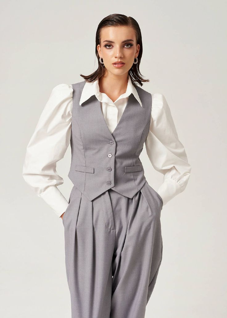 An essential piece that cannot be missing from a cool girl's fall wardrobe is a tailored vest. Easy to style it down with some jeans and sneakers or dress it up with our matching London Pants and London Blazer. Be bold and unbeatable in and out of meetings! four buttons at the front fitted style fully lined For an oversized look size it up!80%pl 20%viBust size: XS 89 cm // S 93 cm // M 97 cm // L 101 cm Waist size: XS 77 cm // S 81 cm // M 85 cm // L 89 cm Length: XS 54.5 cm // S 55.5 cm // M 56 Classic Vest For Workwear In Fall, Classic Vest For Work In Fall, Classic Workwear Vest For Fall, Classic Fall Office Vest, Classic Gray Vest For Work, Tailored Vest For Fall Workwear, Tailored Casual Vest For Fall, Casual Office Vest For Winter, Casual Business Vest For Spring