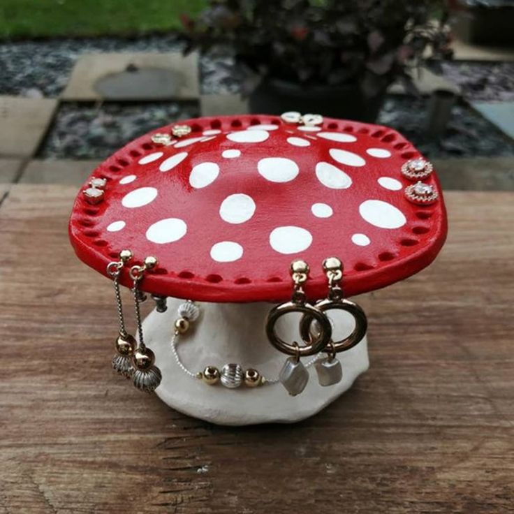 a red and white mushroom sitting on top of a wooden table