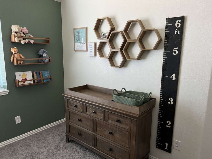 a baby's room with green walls and gray carpet