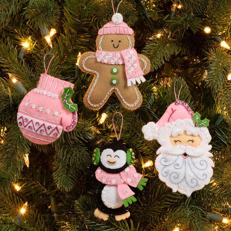 three ornaments are hanging from a christmas tree