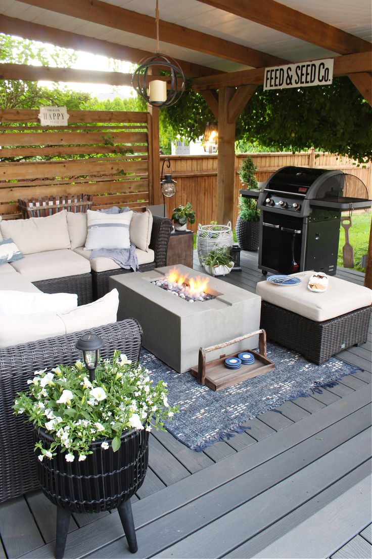 an outdoor living area with patio furniture and fire pit