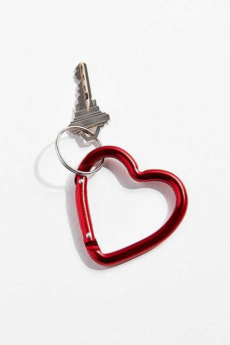 a red heart shaped keychain on a white surface