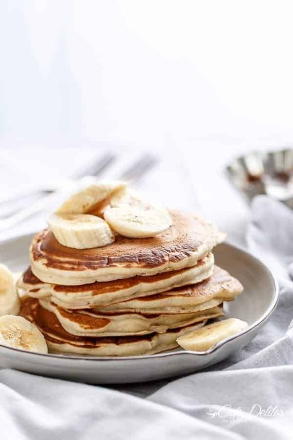 pancakes with bananas and syrup on a plate