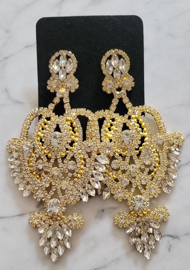 Dainty girls...keep scrolling! These Sasha Chandelier Earrings are large, fierce and of course very GLAM. Dripping in clear or champagne colored stones, these statement earrings are gorgeous enough for some evening time or holiday glam look, and versatile enough to Glam up your daytime looks. ** gold w/ gold available as preorder to be shipped week of 12/12 ** Big Earrings Statement, Jewelry 101, Evening Time, Glam Earrings, Large Statement Earrings, Gold Chandelier Earrings, Engagement Proposal, Holiday Glam, Gold Pendant Jewelry