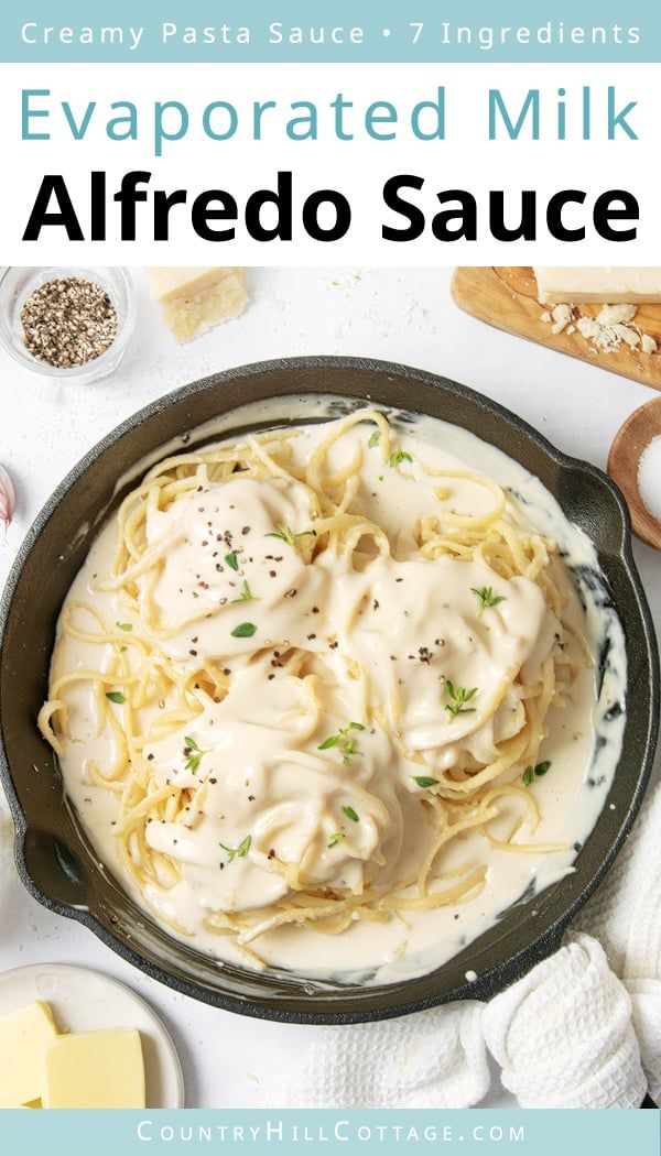 a skillet filled with alfredo sauce on top of a white table next to other ingredients