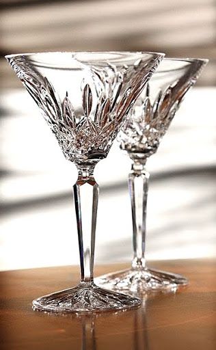 two wine glasses sitting on top of a wooden table