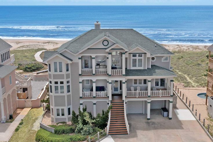 this is an aerial view of a large house on the beach in front of the ocean