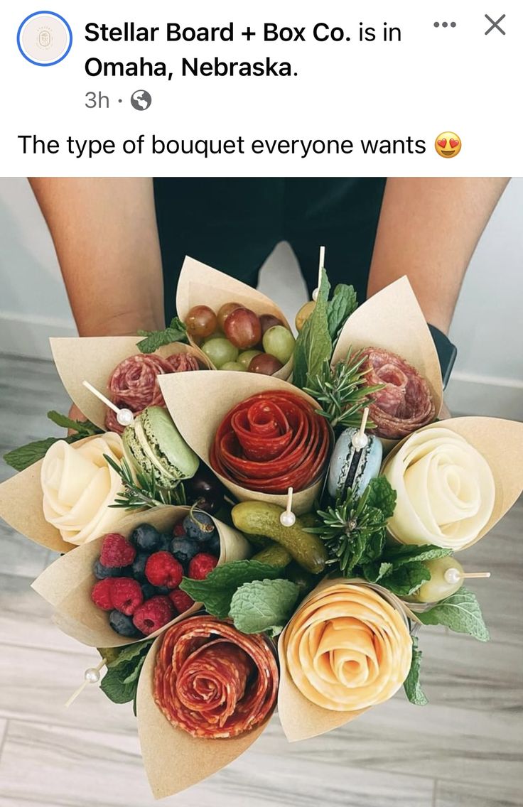 a woman holding a bunch of flowers on top of a wooden floor