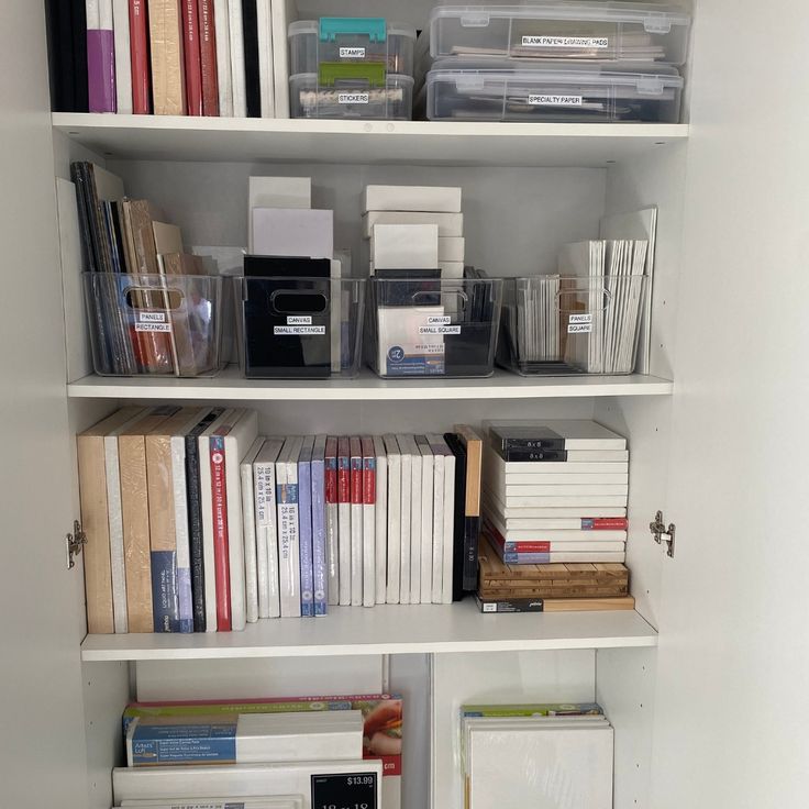 a white book shelf filled with lots of books