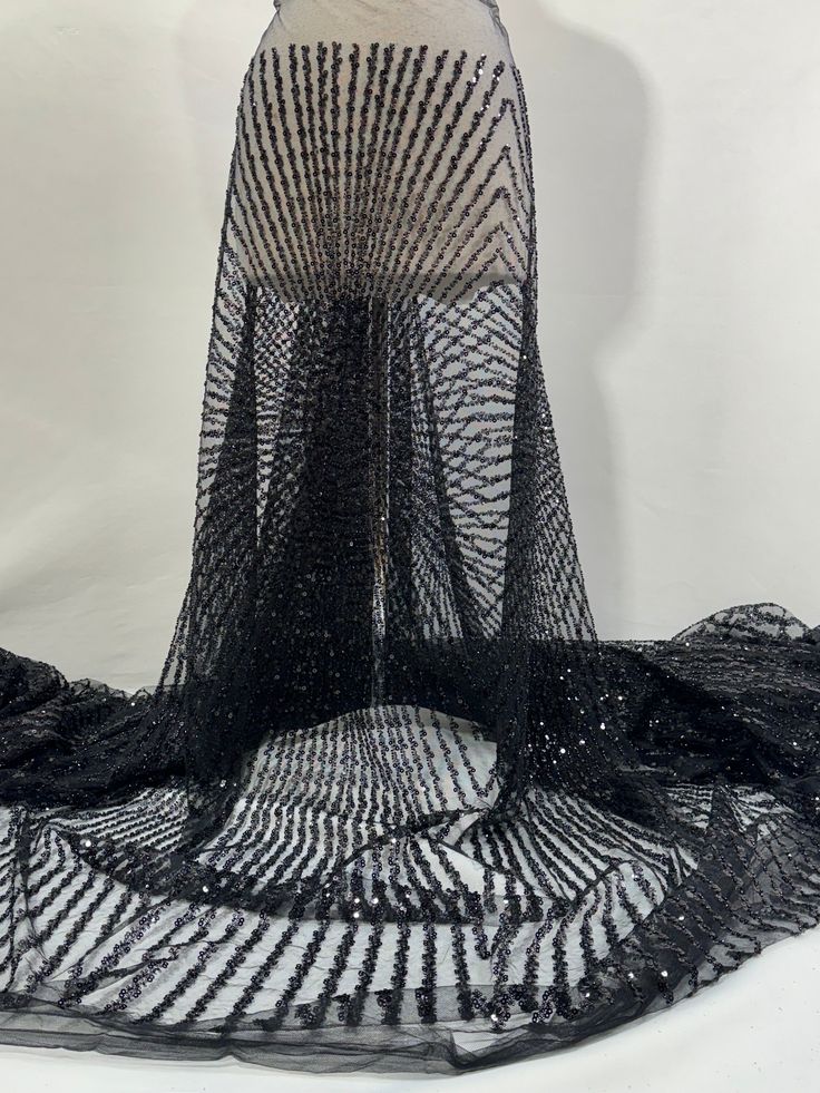 a dress made out of black mesh and sequins