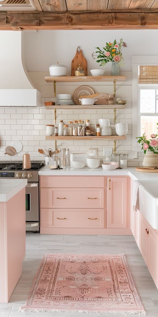 a kitchen with pink cabinets and white counter tops, an area rug on the floor