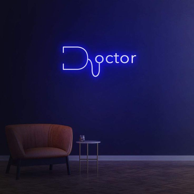 a chair and table in front of a blue wall with the word doctor on it