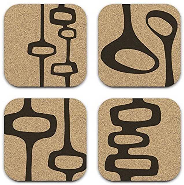 four coasters with black and brown designs on them