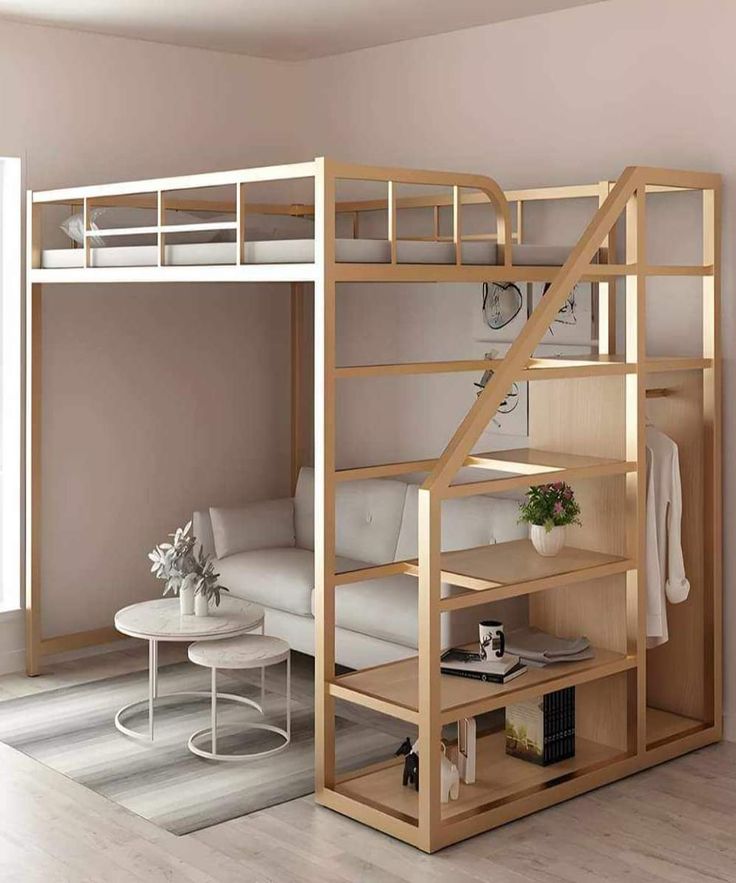 a loft bed with a white couch underneath it and a table under the bed next to it