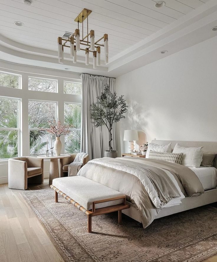 a bedroom with a large bed sitting next to a window and a rug on the floor