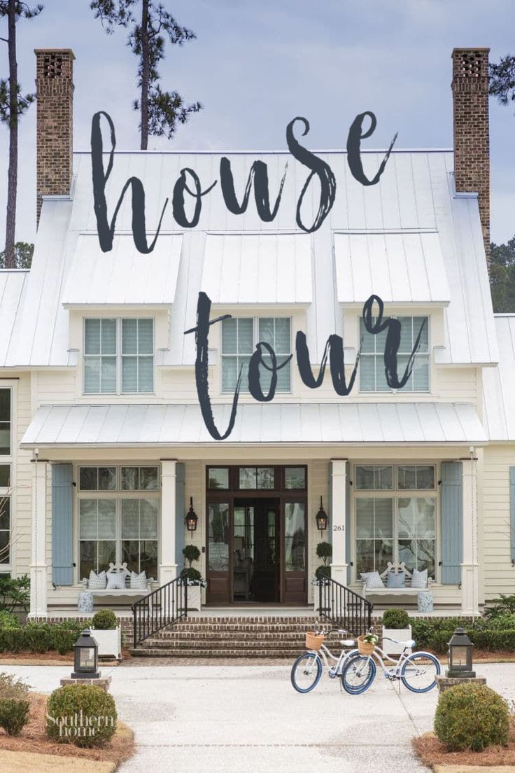 a white house with the words house tour written on it's front door and bicycle parked in front