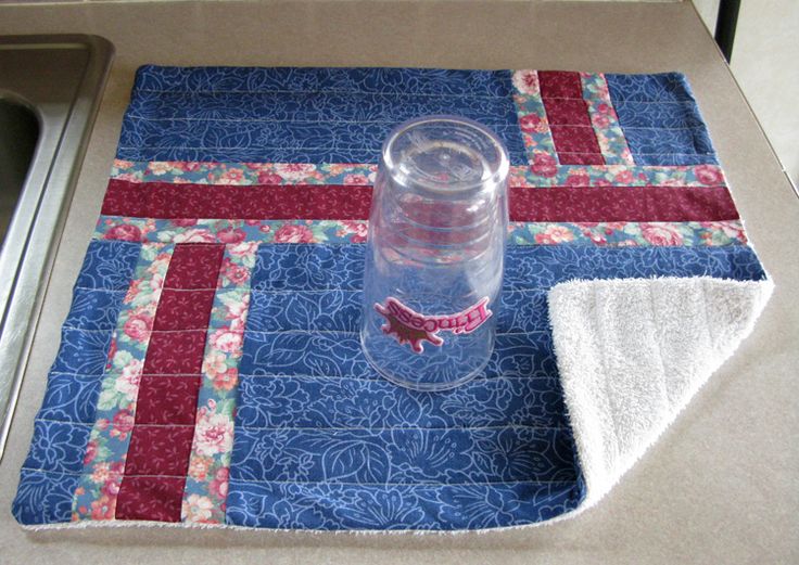 a glass bottle sitting on top of a blue mat