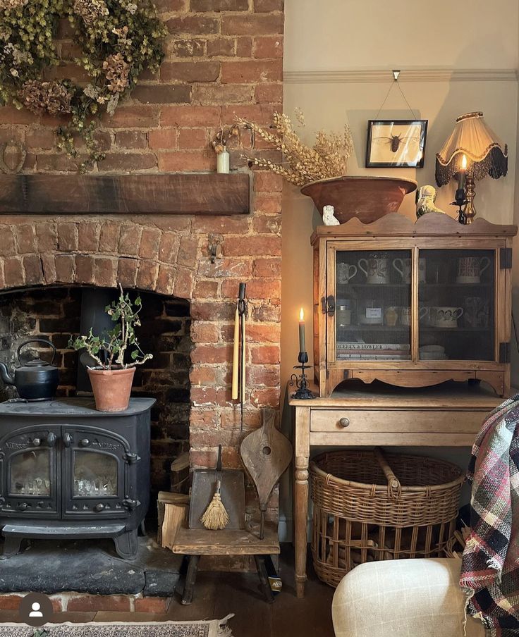 a living room filled with furniture and a fire place in front of a brick wall