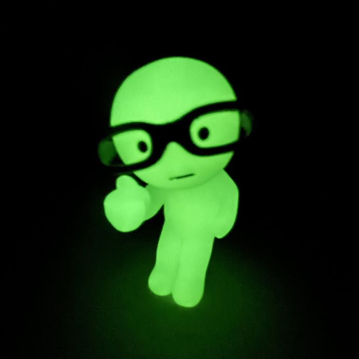 a glow in the dark toy with glasses on it's head and eyes glowing green