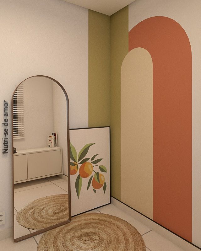 a mirror sitting on top of a white floor next to a wall with fruit painted on it