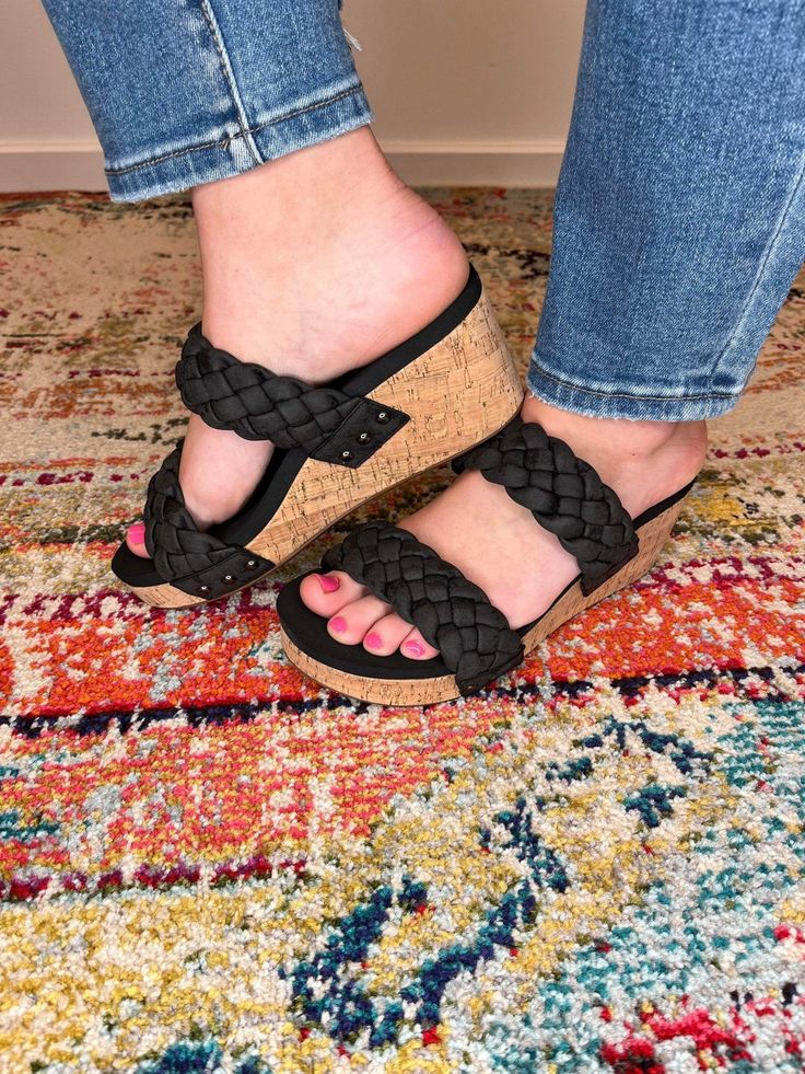 Introducing our must-have Delightful Braided Wedge Sandal, your ultimate choice for all-day style and comfort. Luxuriously crafted with a braided double strap that envelops your foot in blissful comfort, while the memory foam footbed ensures each step is cradled and supported for unparalleled comfort. SUPER Cushioned Footbed 2.5" Cork Wedge Heel Variegated Black with Metallic Fits true to size. If you're a 1/2 size and narrow foot size down; 1/2 size and wider foot size up. Black Wedge Sandals, Beauty Studio, Store Hours, Shopping Stores, Black Metallic, Wedge Sandal, Cork Wedge, Wedge Heels, Wedge Sandals