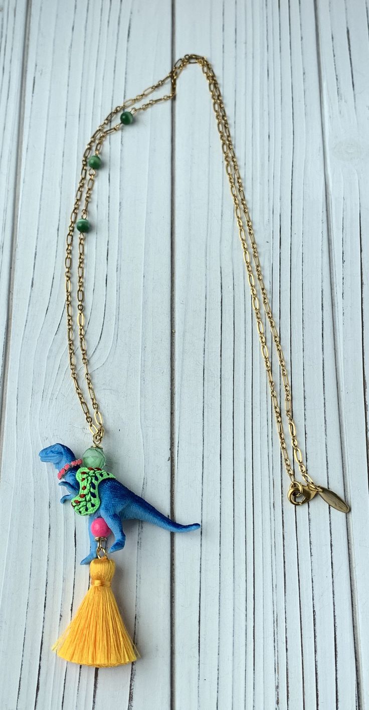 "Introducing fresh new dino styles with well accessorized dinosaur pendant necklace! Great for a dinosaur enthusiast or someone who loves a good statement necklace! Chain measures 35\". Add this to your Lenora Dame collection! Visit my necklace section for other unique dinosaur necklaces including my popular Iconic Dinosaur Necklace. Thanks for looking😊" Dinosaur Necklaces, Pink Football, Dinosaur Pendant, Dinosaur Necklace, Football Stickers, Tiki Room, Bear Necklace, Crafting Materials, Decorative Stickers