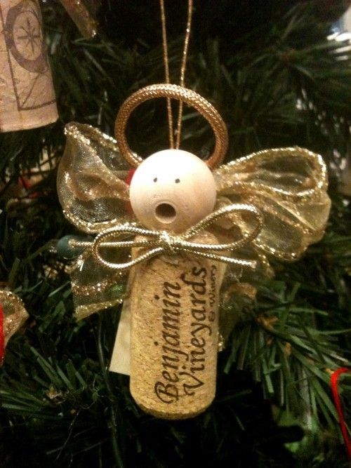 a christmas ornament hanging from a tree with an angel on it's back