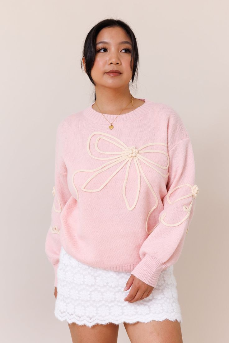 Our Tangled Up Sweater is a cozy and blush pink sweater. It features a textured bow overlay design throughout the body and sleeves. It has a crew neckline and ribbed trims that provide a perfect fit. It has a super soft fabric.Model wears a size smallModel is 5'1"39% Acrylic, 31% Polyester, 30% PolyamideSize small measurements:Bust: 22"Waist: 34" Pink Knit Top For Spring, Feminine Crew Neck Sweater For Winter, Feminine Spring Crew Neck Sweater, Feminine Crew Neck Winter Sweater, Spring Feminine Crew Neck Sweater, Pink Cable Knit Tops For Spring, Feminine Soft Knit Sweater For Spring, Pink Feminine Sweater For Loungewear, Feminine Crew Neck Sweater For Fall