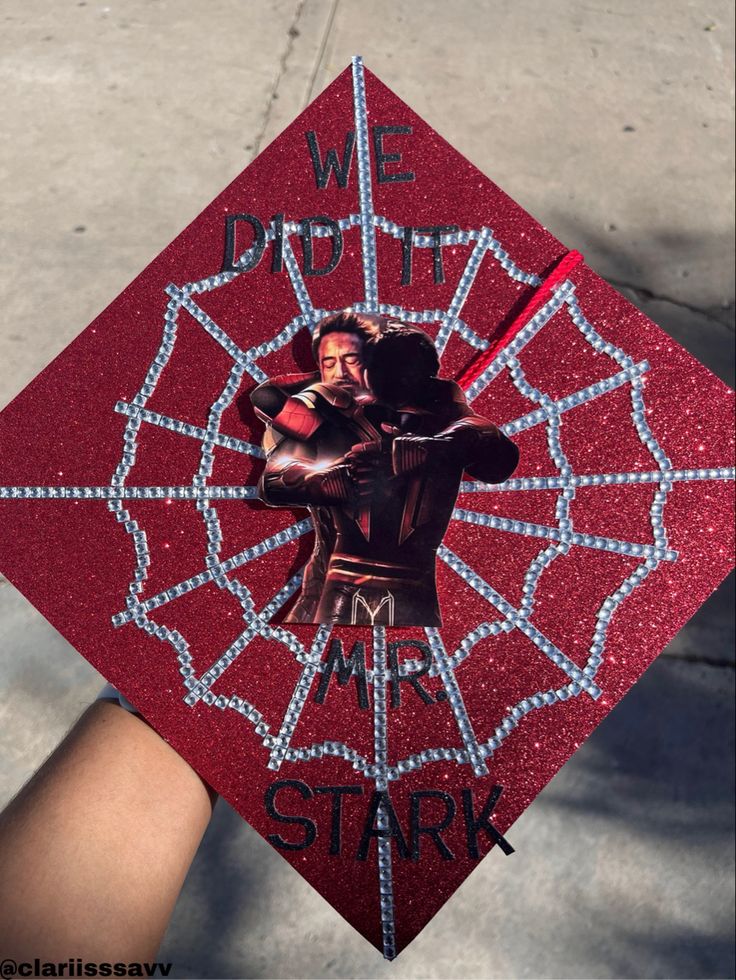 a graduation cap with the words we do it, mr stark in black and red