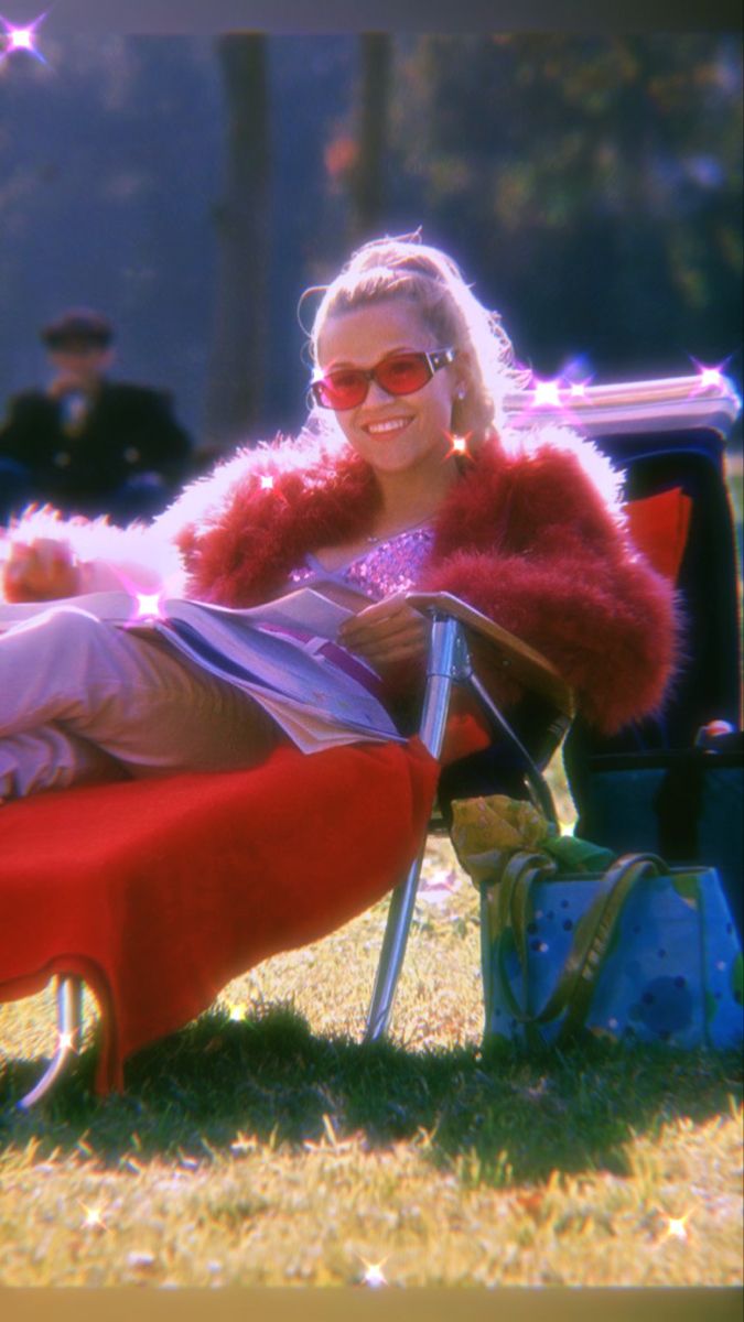 a woman sitting on top of a red bench