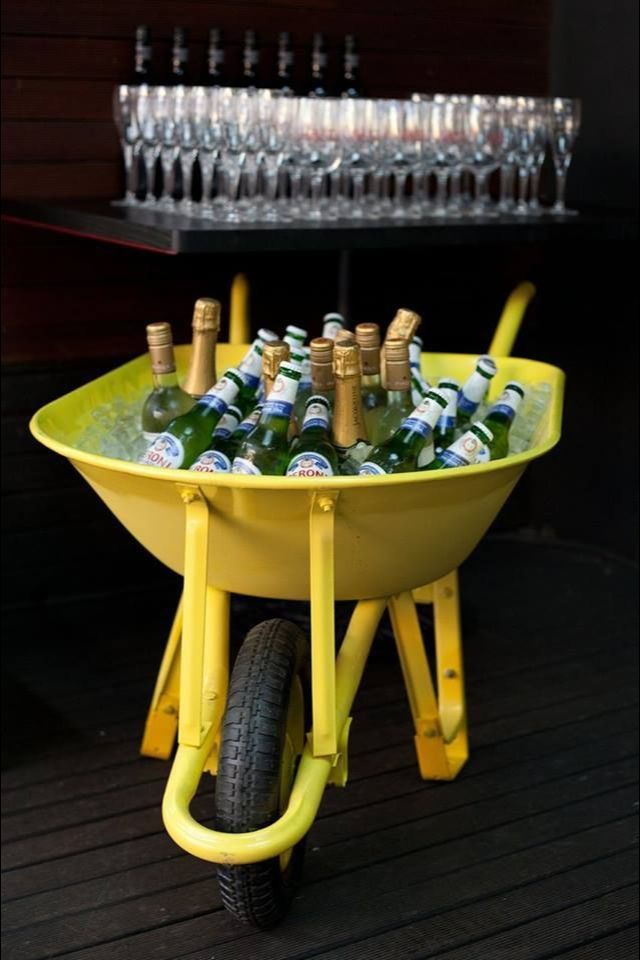 a wheelbarrow filled with bottles of beer