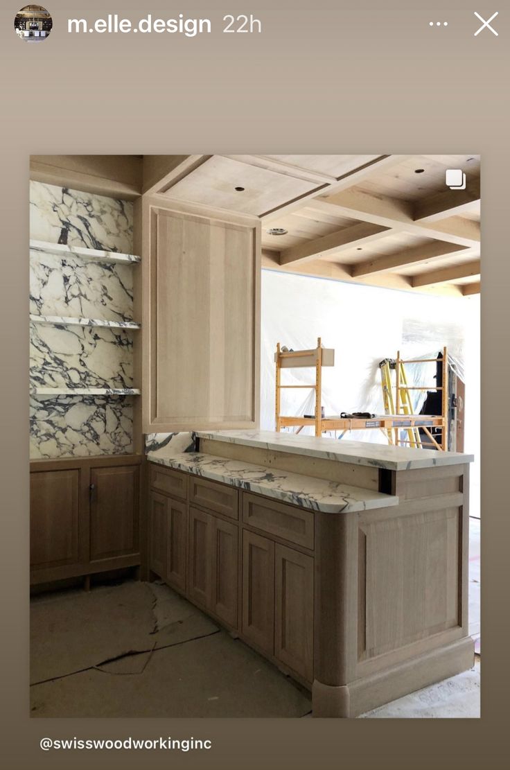 a kitchen with marble counter tops and cabinets in the process of being remodeled by woodworking inc