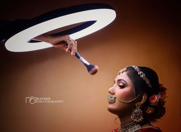 a woman is holding a hair brush in front of her face as she looks up at the ceiling