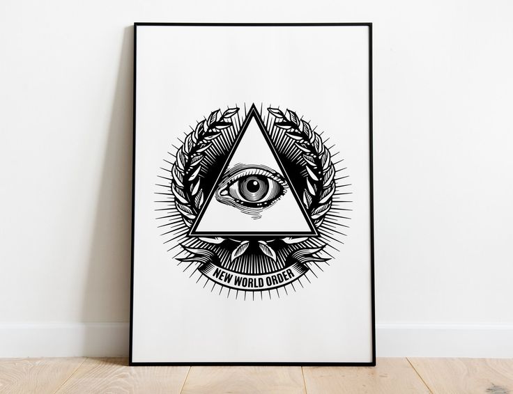 a black and white poster with an all seeing eye in the center on a wooden floor